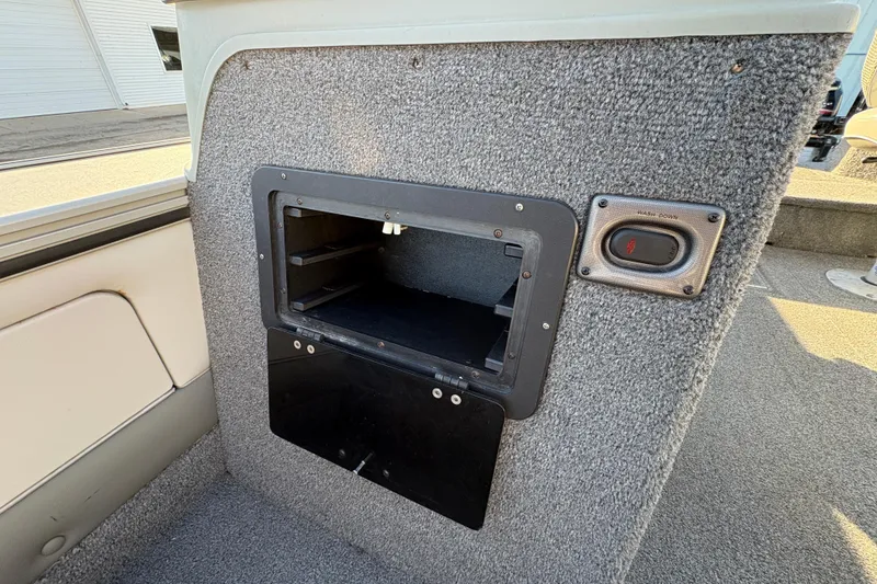 Slide: The Image of 2005 Lund 2025 Pro-V LE boat interior storage compartment with washdown switch. - 19