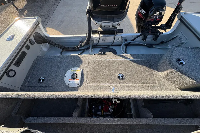 Slide: The Image of 2005 Lund 2025 Pro-V LE boat interior with Mercury engine and storage compartments. - 27