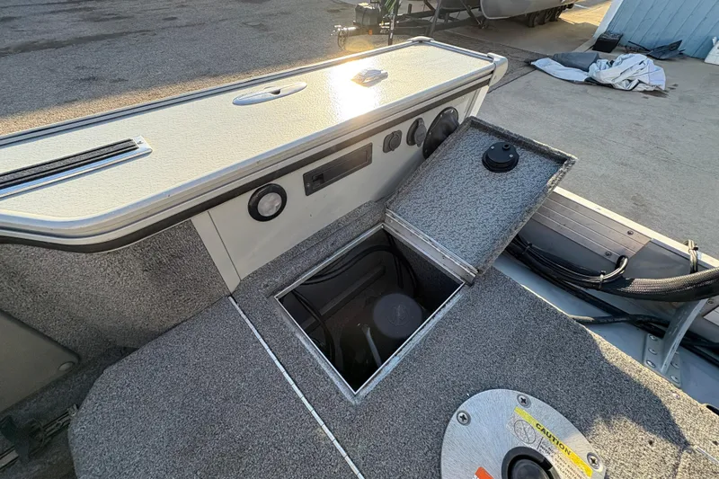 Slide: The Image of 2005 Lund 2025 Pro-V LE boat interior with open storage compartment. - 30