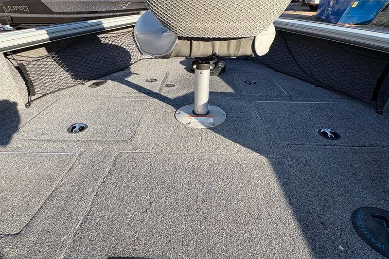 Slide: The Image of 2005 Lund 2025 Pro-V LE boat interior with seating and storage compartments. - 9