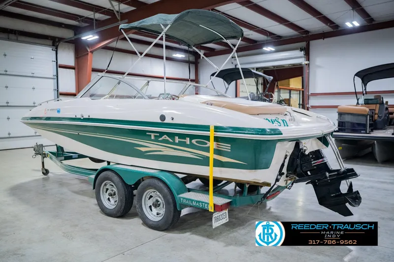 Slide: The Image of 2004 Tahoe 204 boat on trailer in indoor storage facility. - 10