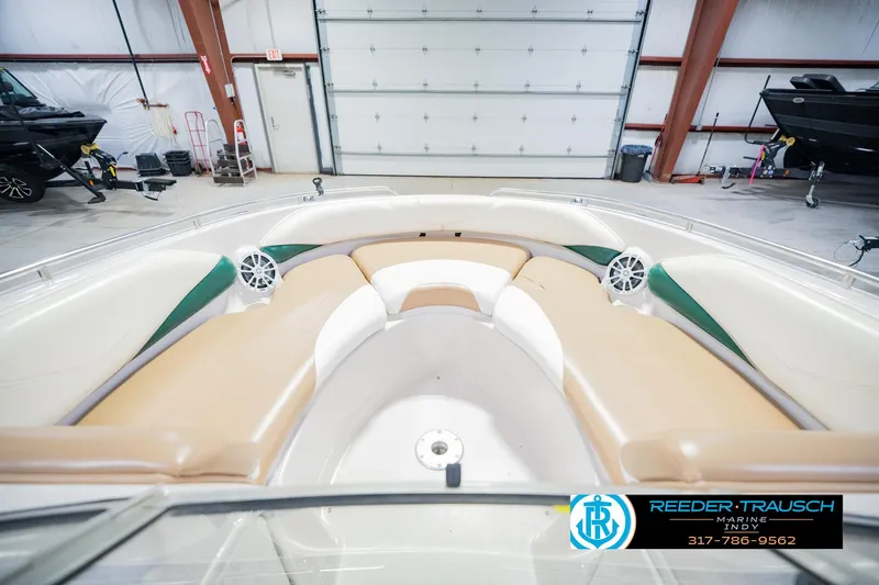 Slide: The Image of 2004 Tahoe 204 boat interior with tan seating and speakers in a garage setting. - 18