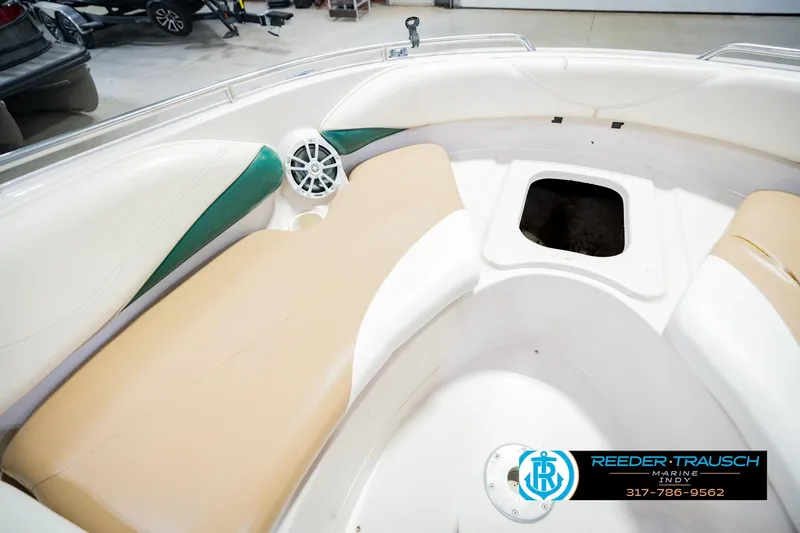 Slide: The Image of Interior of a 2004 Tahoe 204 boat with beige seating and storage compartment. - 26