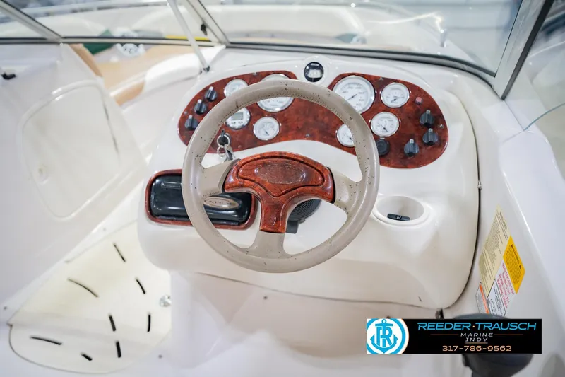 Slide: The Image of 2004 Tahoe 204 boat dashboard with steering wheel and instrument panel. - 28