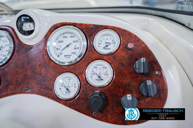 Slide: The Image of Dashboard of a 2004 Tahoe 204 boat with gauges and controls. - 33
