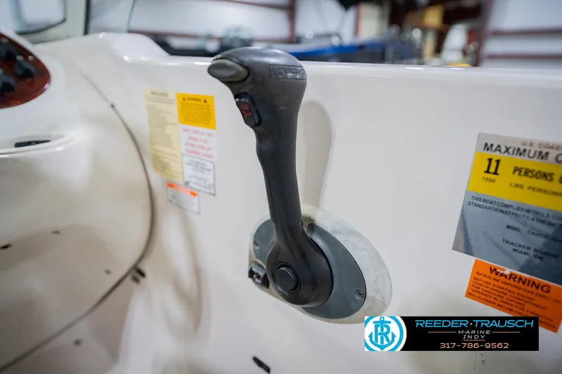 Slide: The Image of Boat throttle control in a 2004 Tahoe 204, with capacity and warning labels visible. - 34