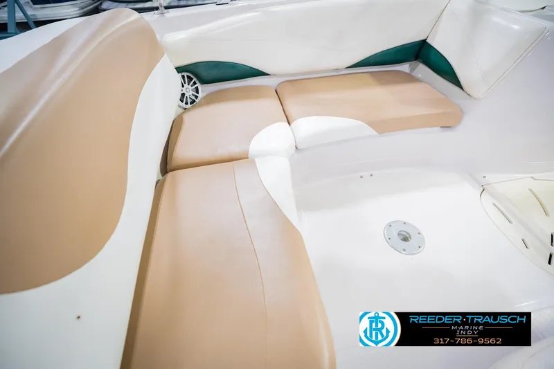 Slide: The Image of 2004 Tahoe 204 boat interior with beige and white seating, Reeder Trausch Marine logo. - 36