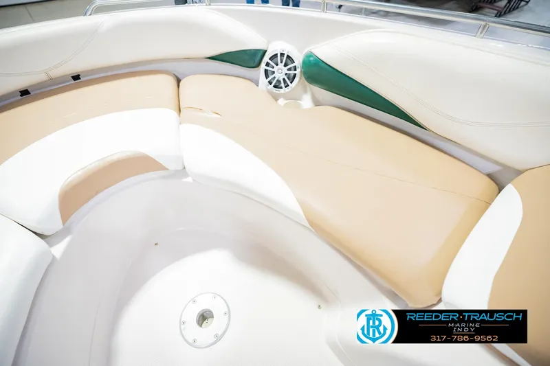 Slide: The Image of 2004 Tahoe 204 boat interior with beige and white seating, featuring a speaker. - 37
