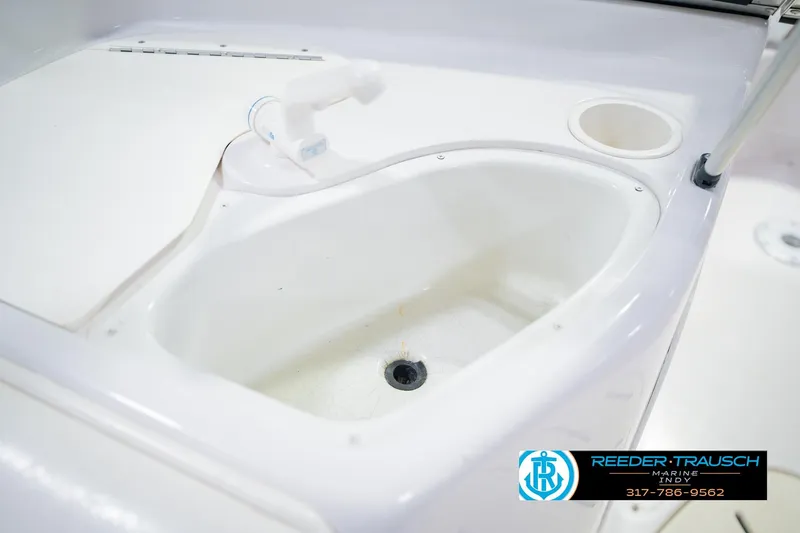 Slide: The Image of 2004 Tahoe 204 boat sink with faucet and cup holder, Reeder Trausch Marine logo. - 40