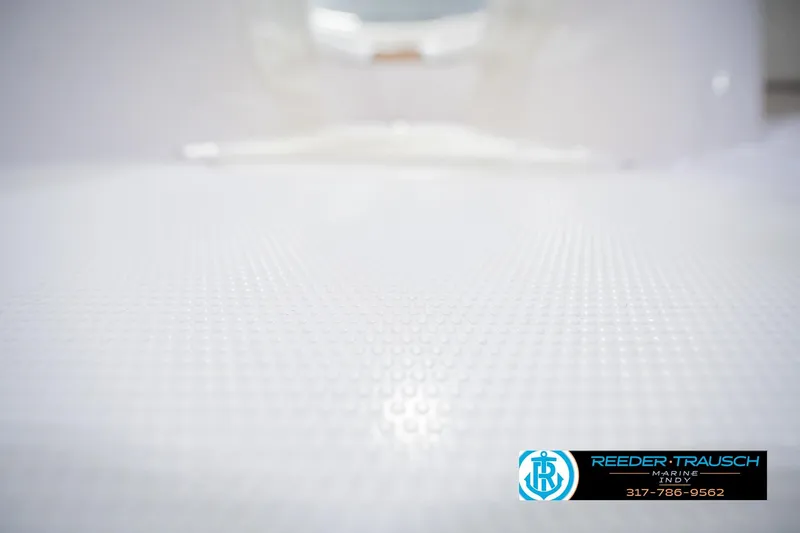 Slide: The Image of White textured surface of a 2004 Tahoe 204 boat, Reeder Trausch Marine logo visible. - 41
