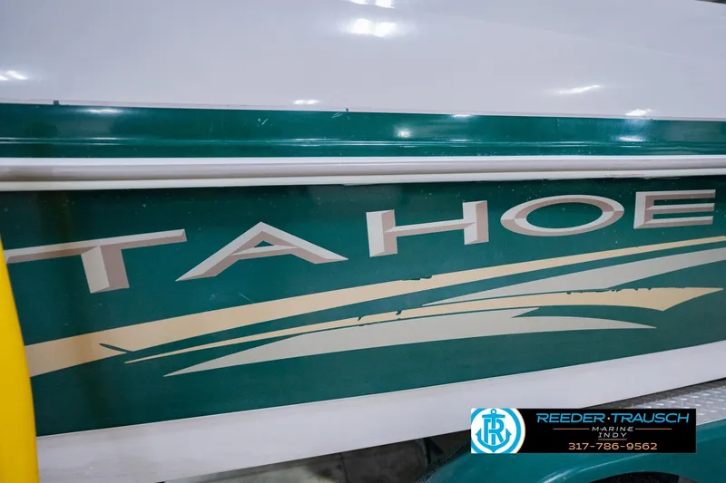 Slide: The Image of 2004 Tahoe 204 boat side view with logo and design details. - 45