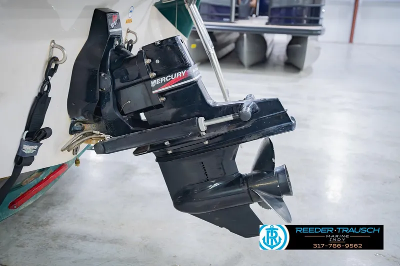 Slide: The Image of 2004 Tahoe 204 boat with Mercury outboard motor in a showroom. - 48