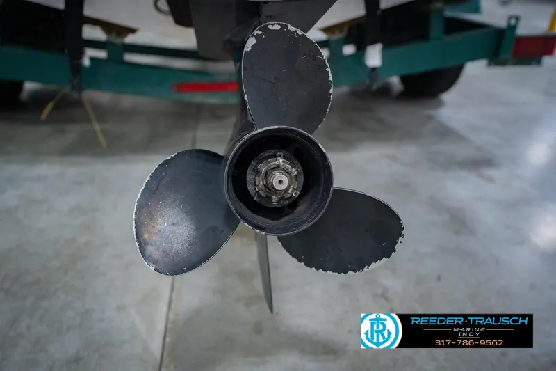 Slide: The Image of Propeller of a 2004 Tahoe 204 boat on a trailer in a garage. - 51