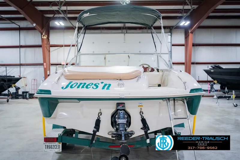 Slide: The Image of 2004 Tahoe 204 boat in a warehouse, featuring "Jones'n" text on the back. - 9