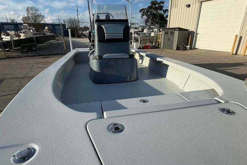 Slide: The Image of 2021 Blazer Bay 2420 boat with spacious deck and center console in a marina setting. - 10