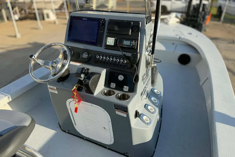 Slide: The Image of 2021 Blazer Bay 2420 boat console with steering wheel and navigation equipment. - 15
