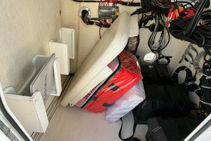 Slide: The Image of 2021 Blazer Bay 2420 boat storage compartment with wiring and equipment. - 16