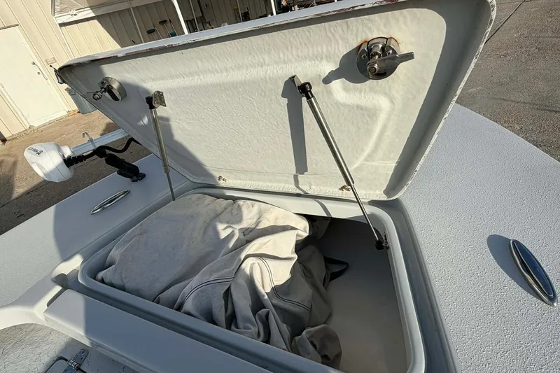 Slide: The Image of Open storage compartment on 2021 Blazer Bay 2420 boat with fabric inside. - 23