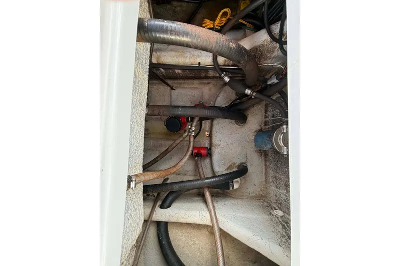 Slide: The Image of 2021 Blazer Bay 2420 boat interior showing hoses and mechanical components. - 24