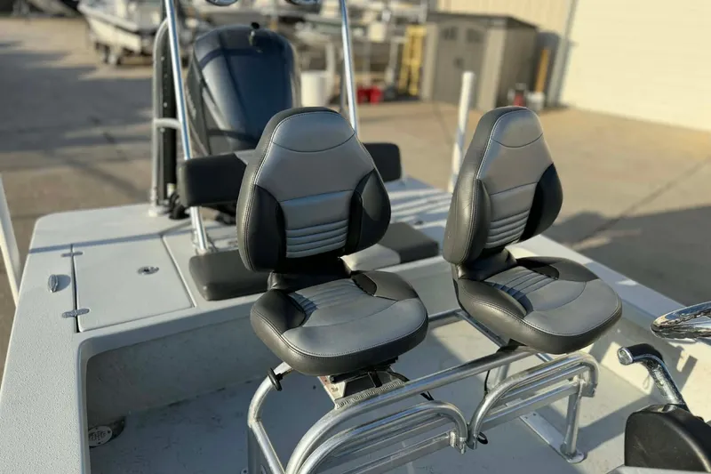 Slide: The Image of 2021 Blazer Bay 2420 boat seats, featuring sleek black and gray design. - 25
