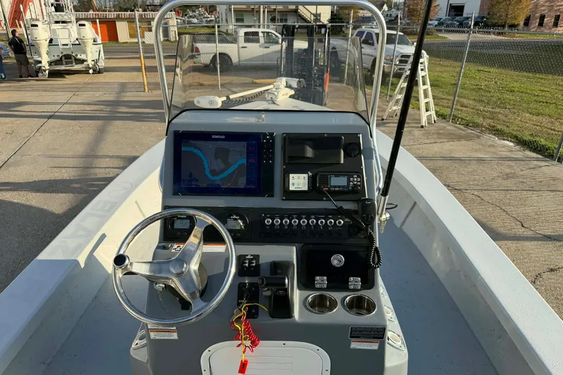 Slide: The Image of 2021 Blazer Bay 2420 boat dashboard with navigation system and controls. - 29