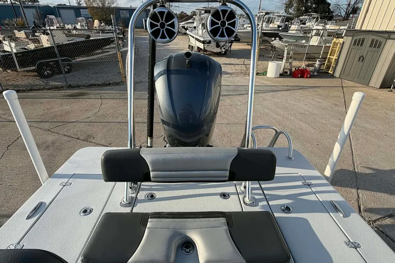 Slide: The Image of 2021 Blazer Bay 2420 boat with speakers and motor, docked in a marina. - 30