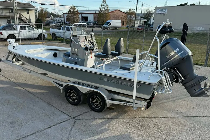 Slide: The Image of 2021 Blazer Bay 2420 boat with Yamaha engine on trailer, parked outdoors. - 6