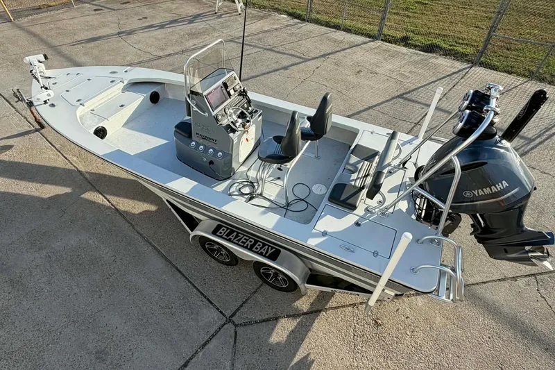 Slide: The Image of 2021 Blazer Bay 2420 boat with Yamaha engine, parked on concrete surface. - 7