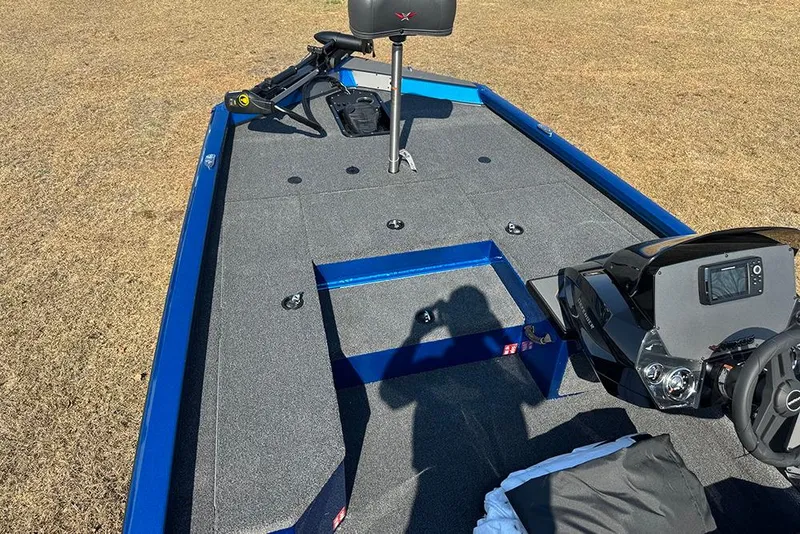 Slide: The Image of 2026 Vexus Defender 181 boat interior with steering console and seating on grass. - 10