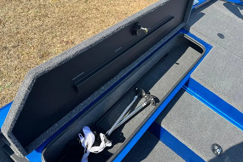 Slide: The Image of Open storage compartment in 2026 Vexus Defender 181 boat, showing interior and equipment. - 11