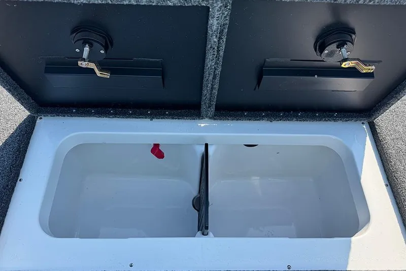 Slide: The Image of Livewell compartment in 2026 Vexus Defender 181 boat, featuring dual lids and secure latches. - 25