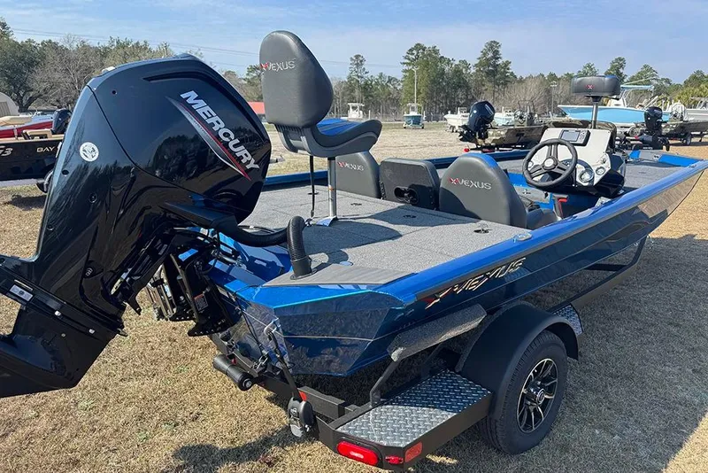 Slide: The Image of 2026 Vexus Defender 181 boat with Mercury engine, parked outdoors on a trailer. - 5