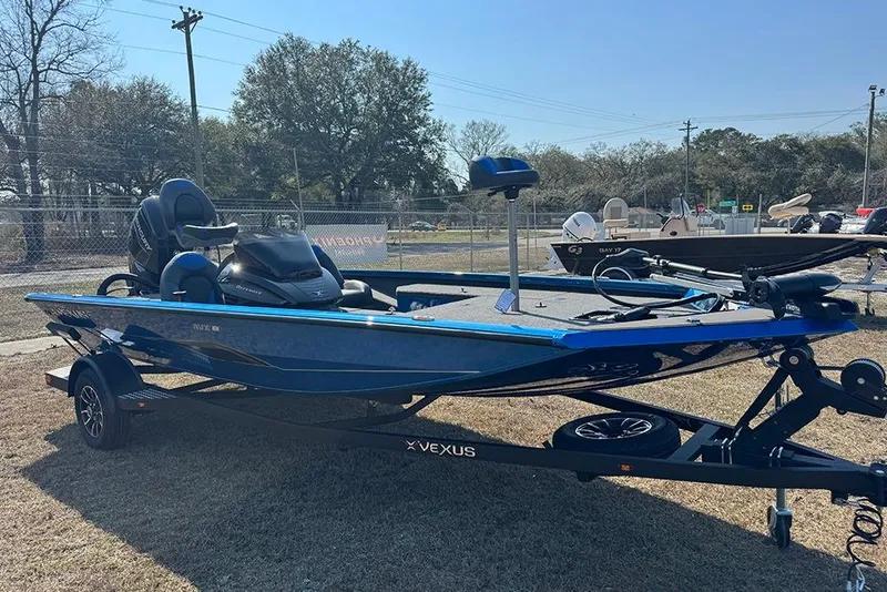 Slide: The Image of 2026 Vexus Defender 181 boat on trailer, displayed outdoors. - 7