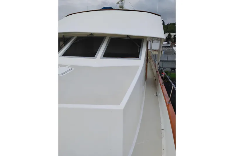 Slide: The Image of 1977 Custom International Offshore 65 yacht deck with sleek design and large windows. - 10