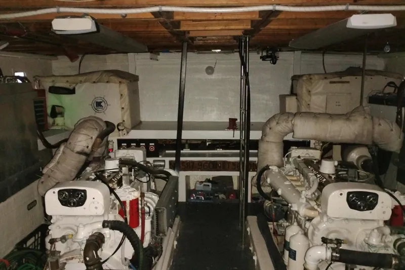 Slide: The Image of Engine room of a 1977 Custom International Offshore 65 yacht, featuring dual engines. - 100