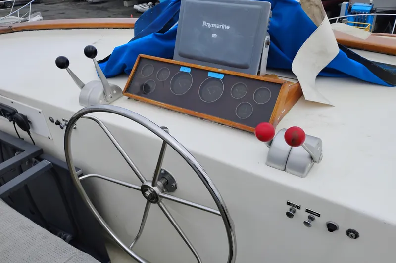 Slide: The Image of Cockpit of 1977 Custom International Offshore 65 boat with steering wheel and controls. - 14