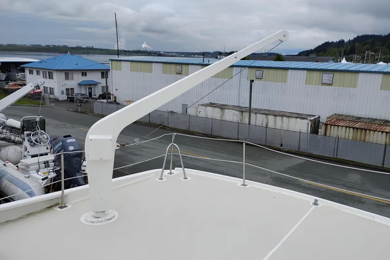 Slide: The Image of Rooftop view of a 1977 Custom International Offshore 65 yacht with marina background. - 16