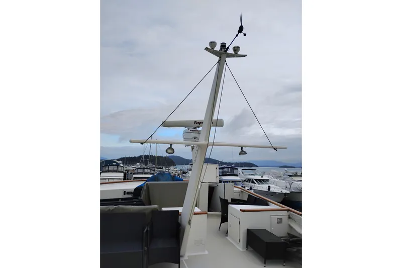 Slide: The Image of 1977 Custom International Offshore 65 yacht deck with radar and seating area. - 17