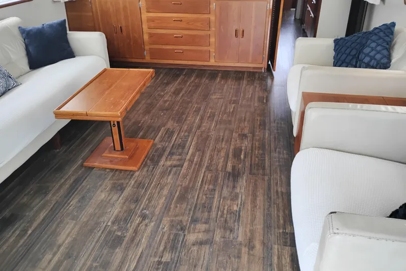 Slide: The Image of Interior of 1977 Custom International Offshore 65 yacht with wooden flooring and cozy seating. - 22