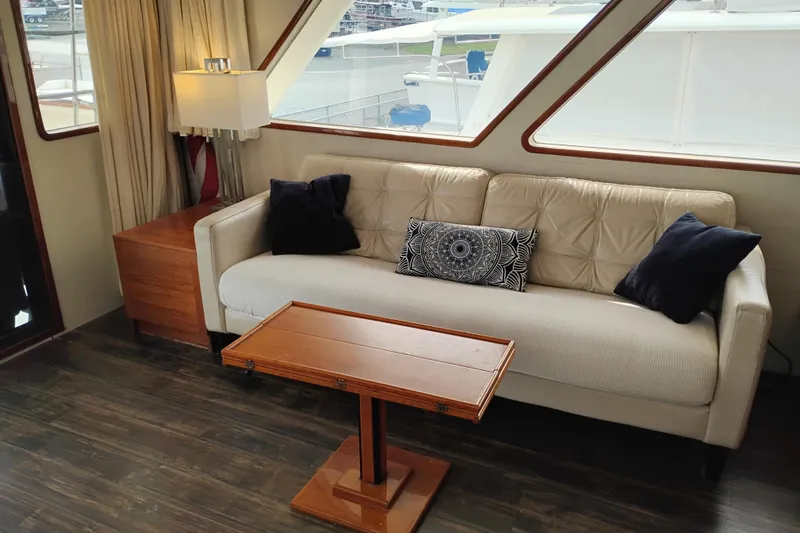 Slide: The Image of Luxurious interior of 1977 Custom International Offshore 65 yacht with elegant sofa and wooden table. - 23