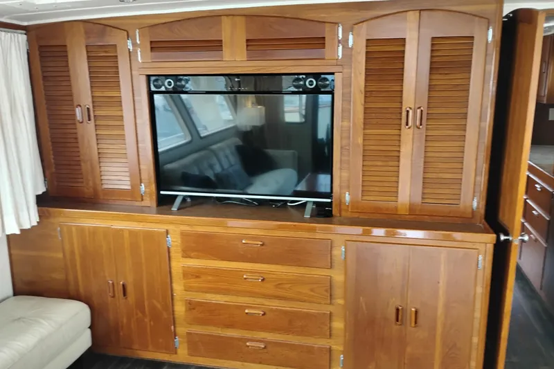 Slide: The Image of Wooden cabinetry with built-in TV on 1977 Custom International Offshore 65 yacht. - 25