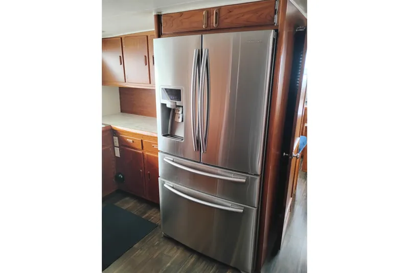 Slide: The Image of Stainless steel refrigerator in a wooden kitchen on a 1977 Custom International Offshore 65. - 28
