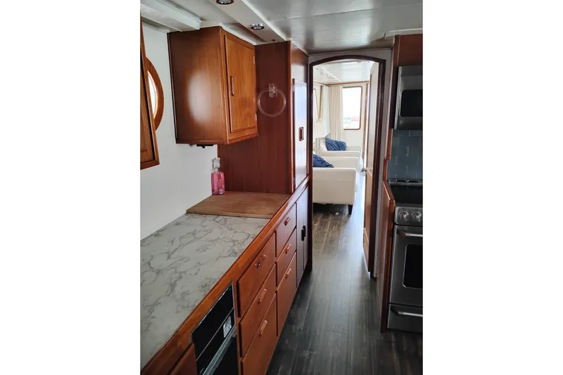 Slide: The Image of Interior of 1977 Custom International Offshore 65 yacht with wooden cabinetry and modern appliances. - 31