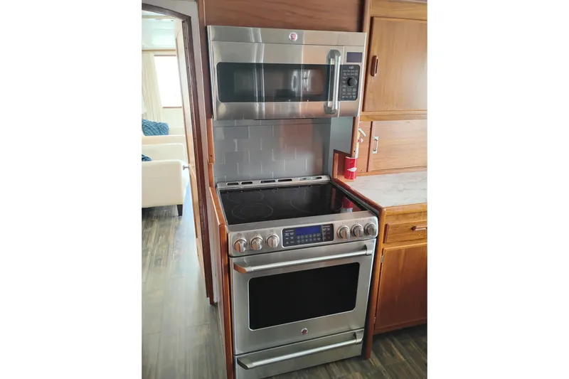 Slide: The Image of Modern kitchen with stainless steel stove and microwave in a 1977 International Offshore 65 yacht. - 32