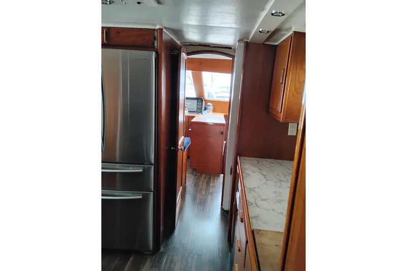 Slide: The Image of Interior view of a 1977 Custom International Offshore 65 yacht kitchen area. - 35