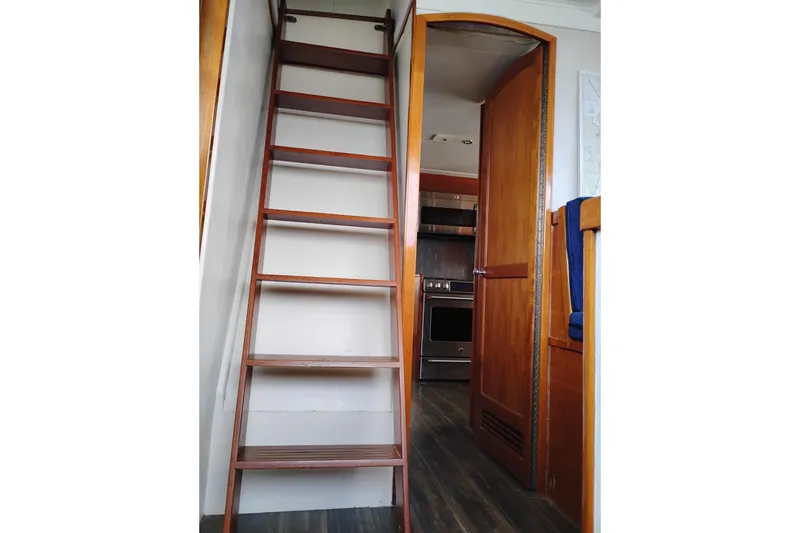 Slide: The Image of Interior of 1977 Custom International Offshore 65 yacht with wooden ladder and open door. - 36