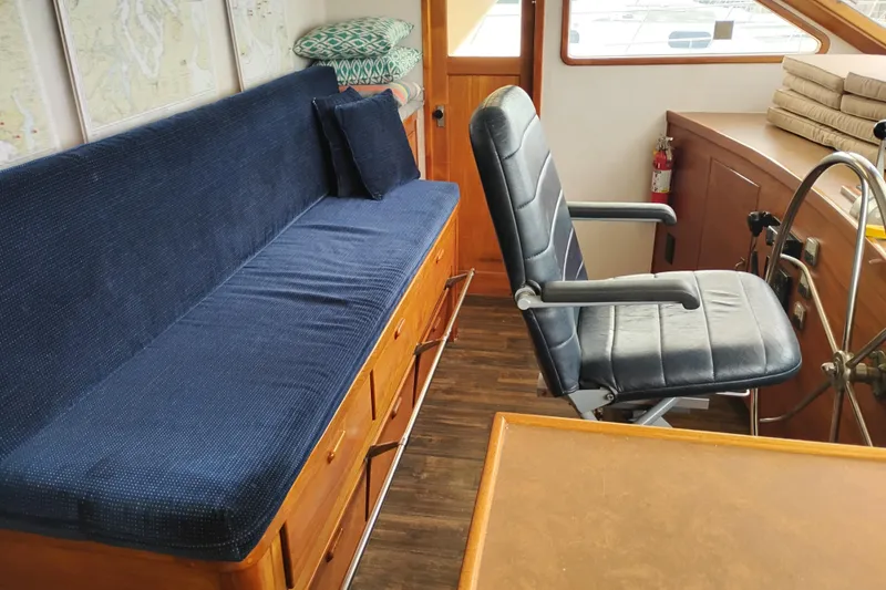 Slide: The Image of Interior of 1977 Custom International Offshore 65 yacht with blue seating and steering wheel. - 39