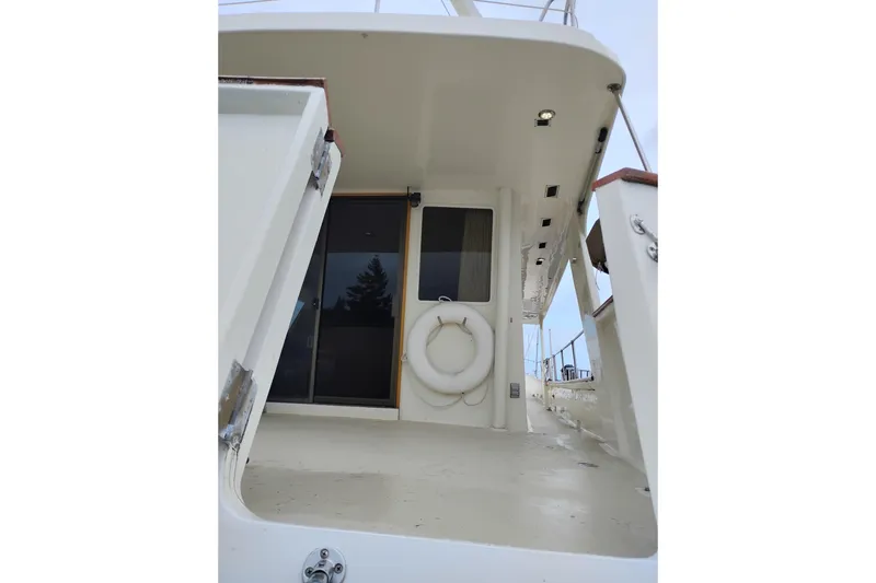 Slide: The Image of 1977 Custom International Offshore 65 yacht deck with life preserver and sliding door. - 4