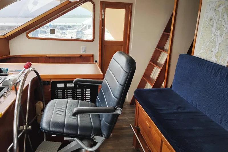 Slide: The Image of Interior of a 1977 Custom International Offshore 65 yacht with helm and seating area. - 40