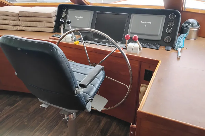 Slide: The Image of Cockpit of 1977 Custom International Offshore 65 yacht with steering wheel and navigation equipment. - 42